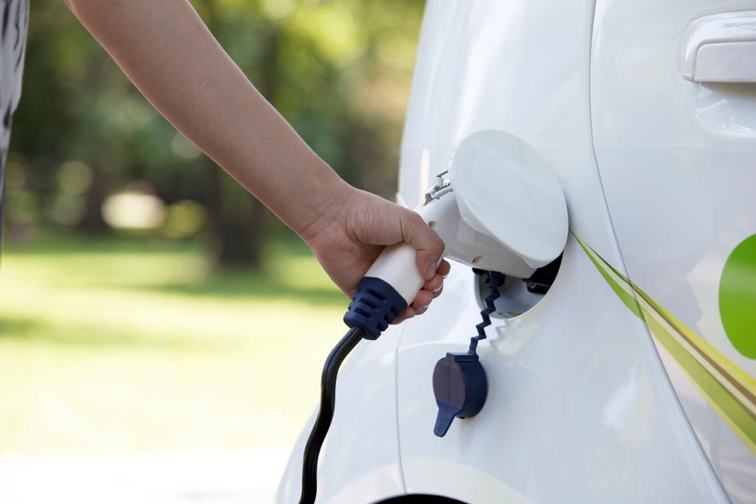 an electric charger being plugged into a car